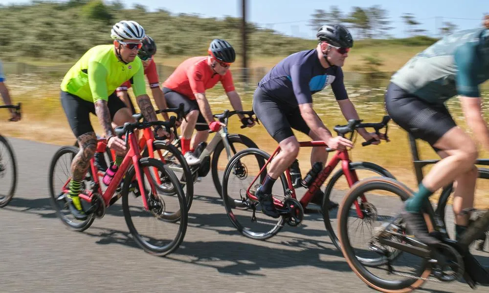 road cyclist riding in a bunch on a sunny summer day