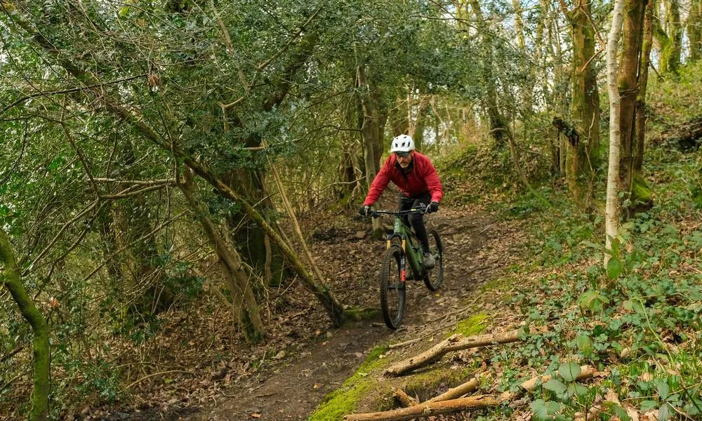 Descending a trail on an Orange Phase EVO