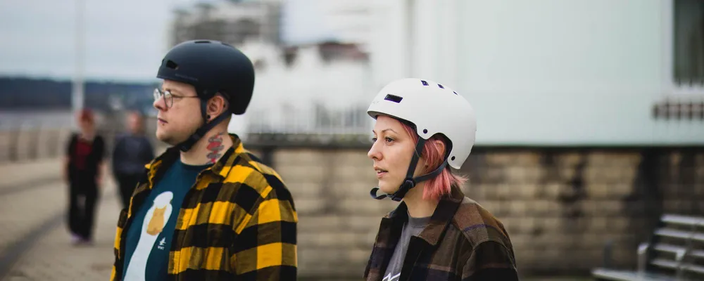 couple wearing skate helmets