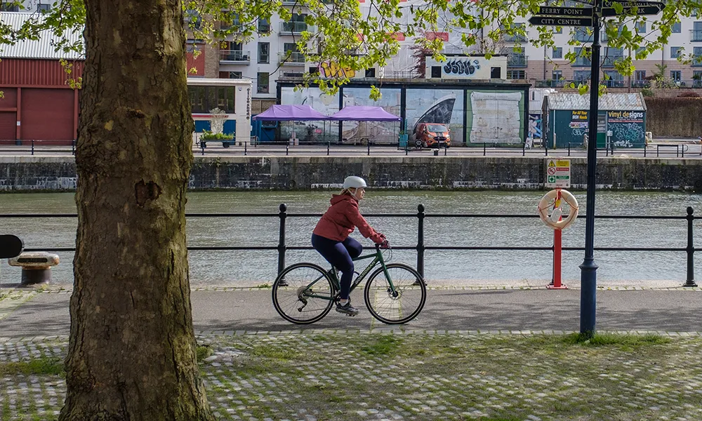 a hybrid sports bike is ridden close to a river