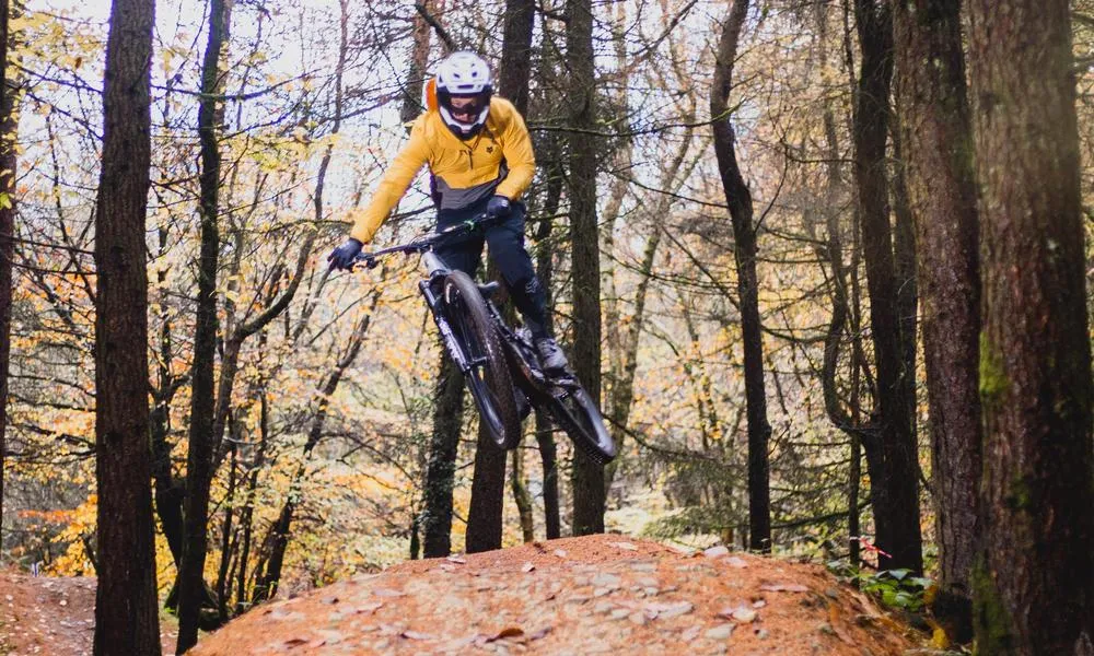 MTB rider in autumn clearing a jump