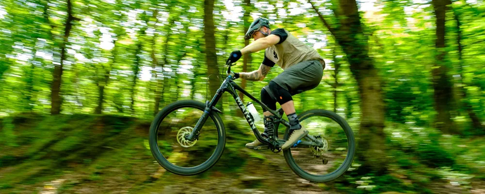 mountain biker jumping with kneepads