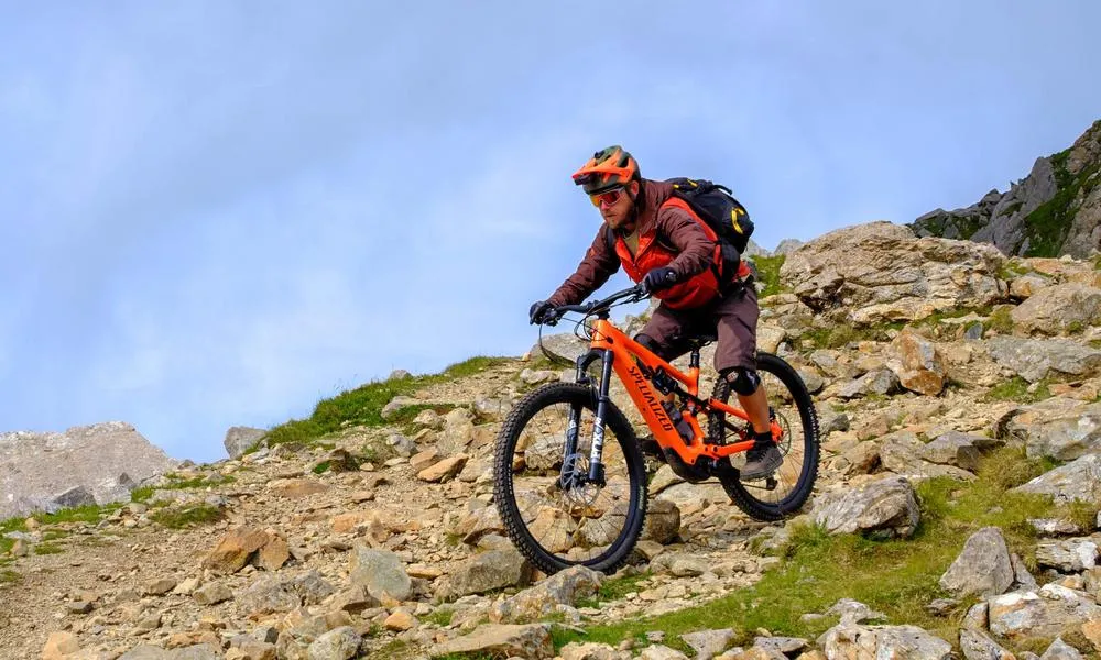 MTB rider descending a mountain on a specialized