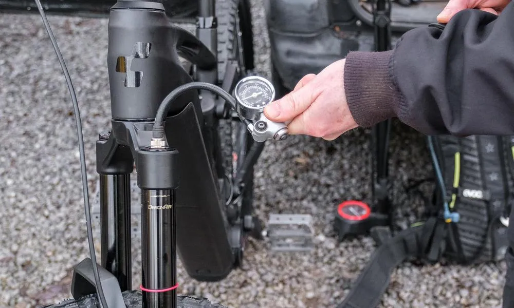 pumping up a fork on an mtb with a shock pump