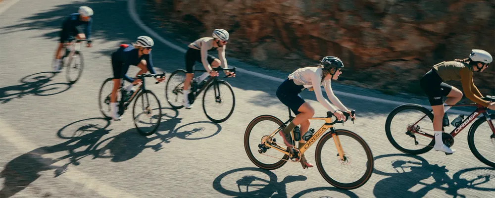 A group of people ride electric road bikes