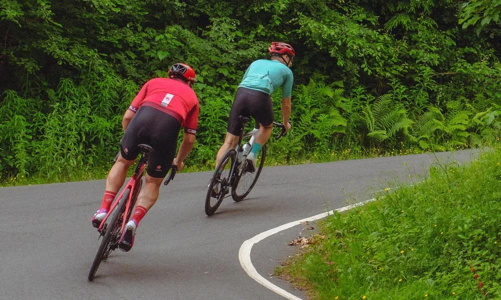 two road cyclists climbing