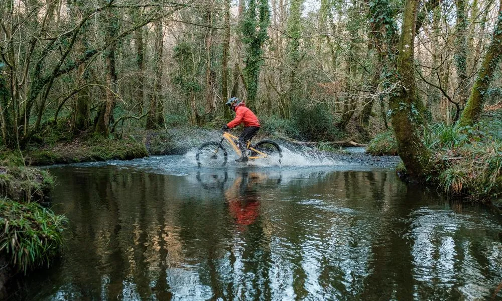 MTB rider crossing a river