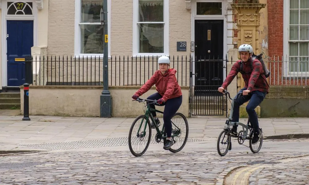 Urban riders on a coble stone road