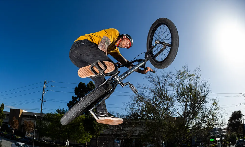 close up on tyres as a bmx jumps through the air