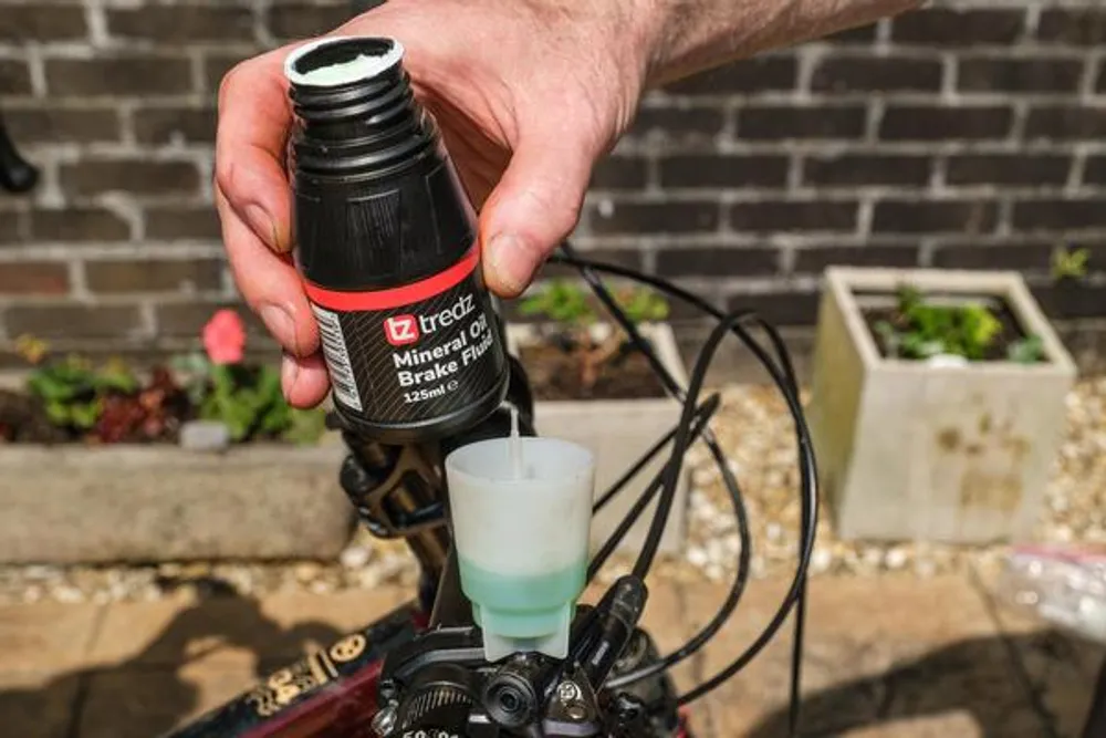 brake fluid next to a bleed bucket