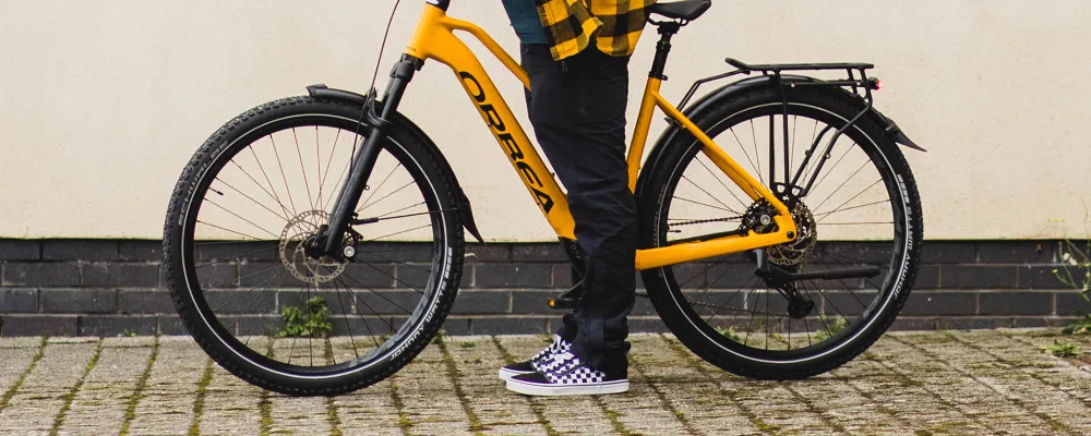 a hybrid bicycle rests close up on the tyres