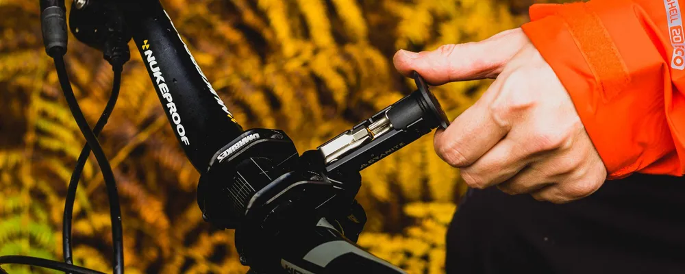 a trail tool is removed from a mountain bike steerer tube