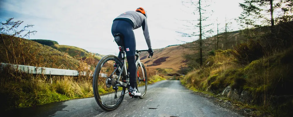 man cycling on a winter day wearing leg warmers in the welsh hills