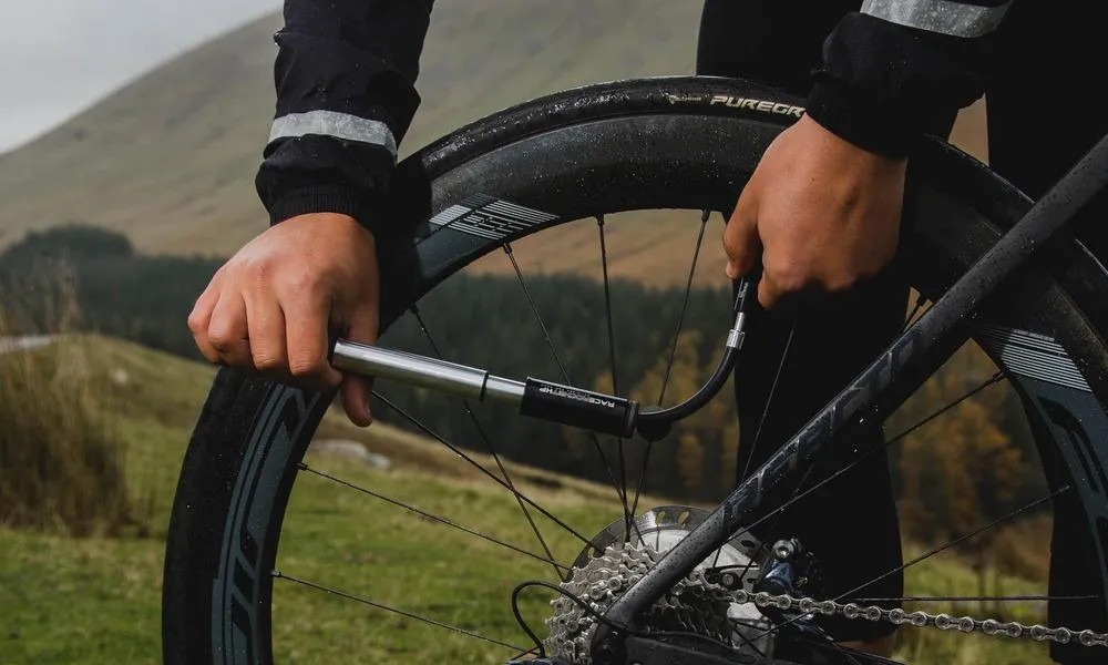 Pumping up a  road bike tyre with a hand pump