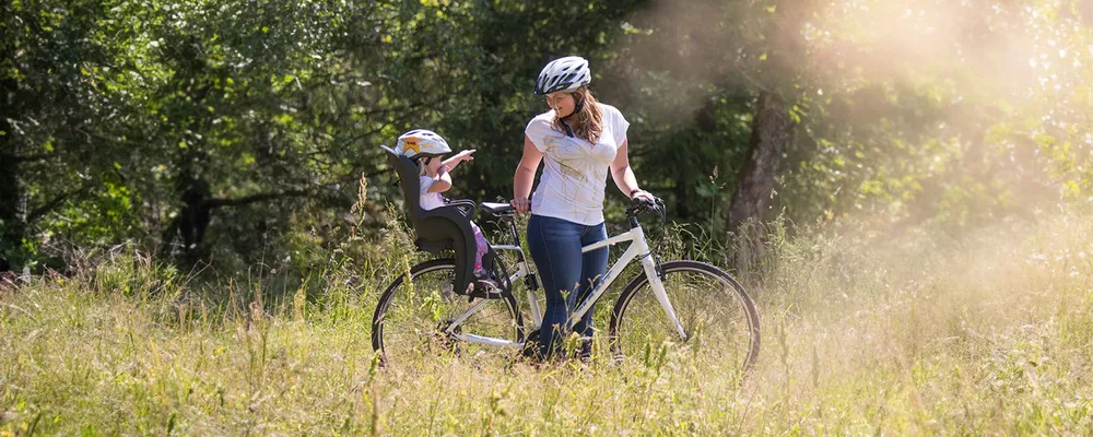 woman with child on a bike with a child seat