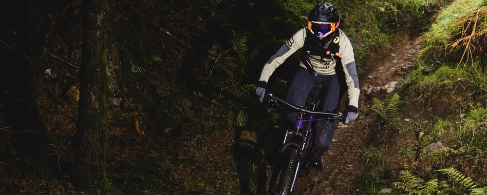 MTB rider cycling through the woods