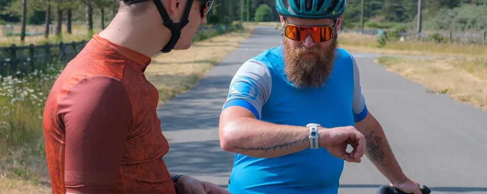 cyclist checking their activity monitor watch