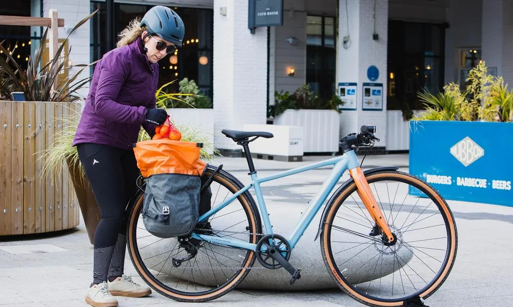 Cyclist loading up a pannier bag