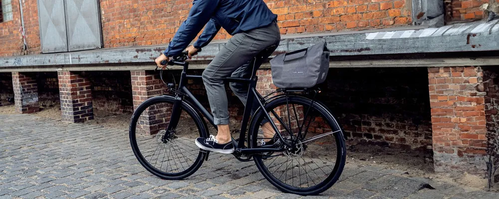 riding a bike with a trunk bag on rear rack