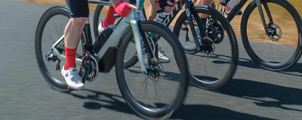 three road riders close up showing wheels and shoes