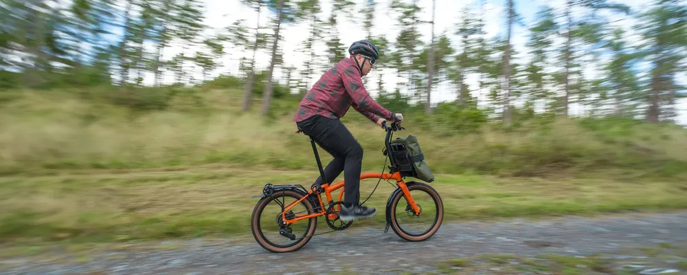 Riding a Brompton G Line folding bike on a gravel track - pan shot