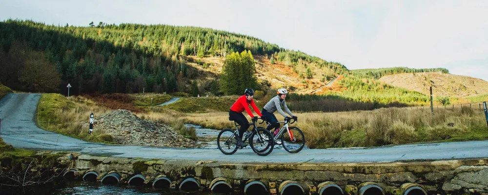 cyclists riding through valley 