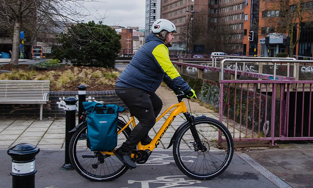 riding an electric urban bike on a city cycle path