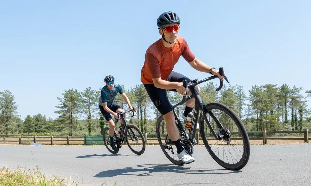 two cyclists out the saddle in altura kit