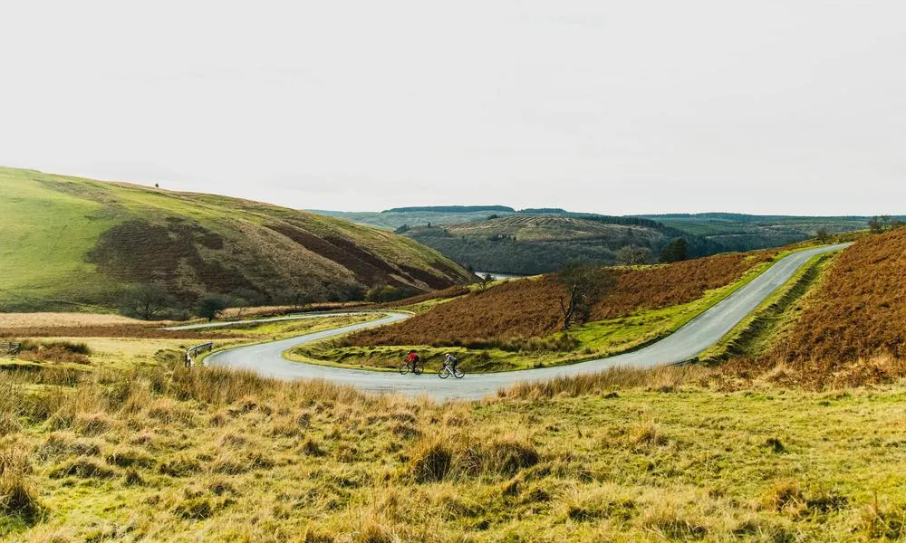 two road cyclists on road corner