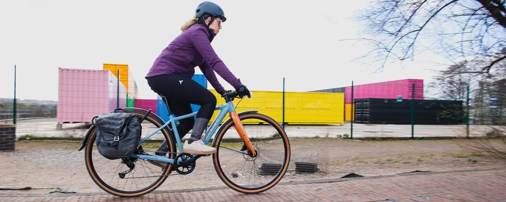 cyclist riding a bike with pannier bags