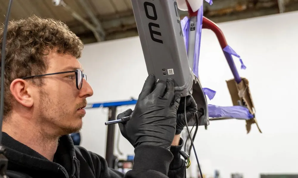 Mechanic working on bottom bracket of mondraker