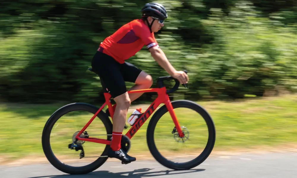 road cyclist riding a red Giant road bike in a red top