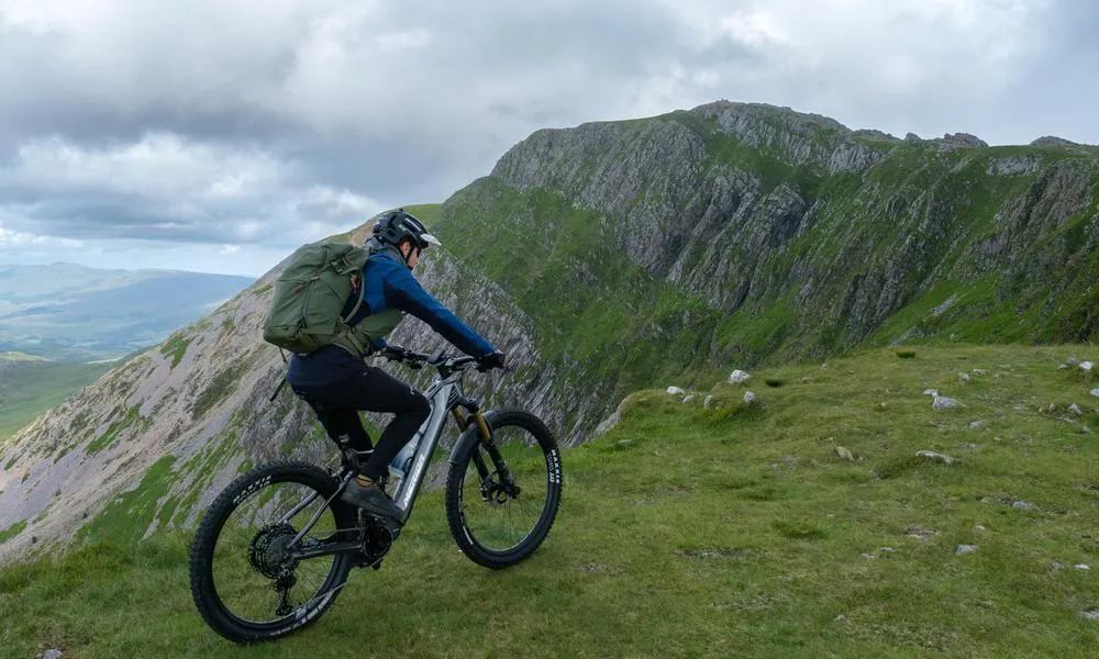 rider in the mountains on electric mountain bike 