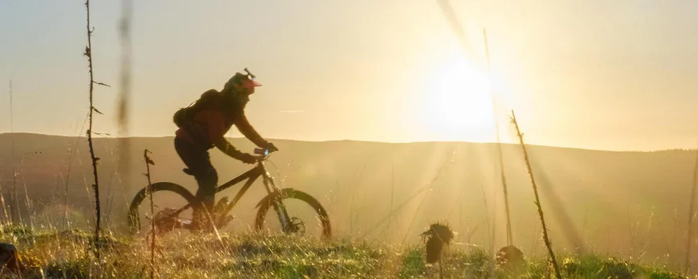 Mountain biker riding in the hills at sunrise