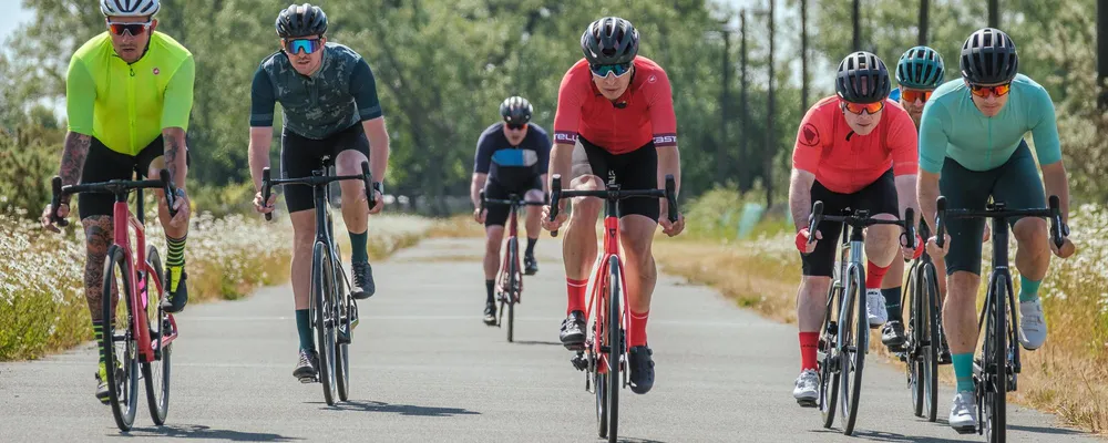 road cyclists riding abreast on a sunny day