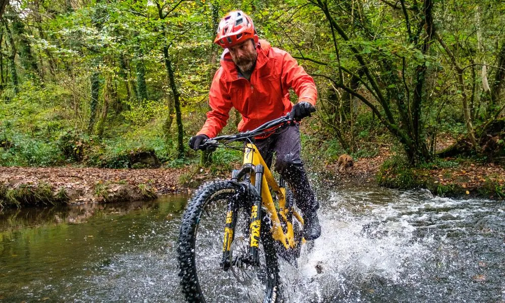 MTB rider going through a river