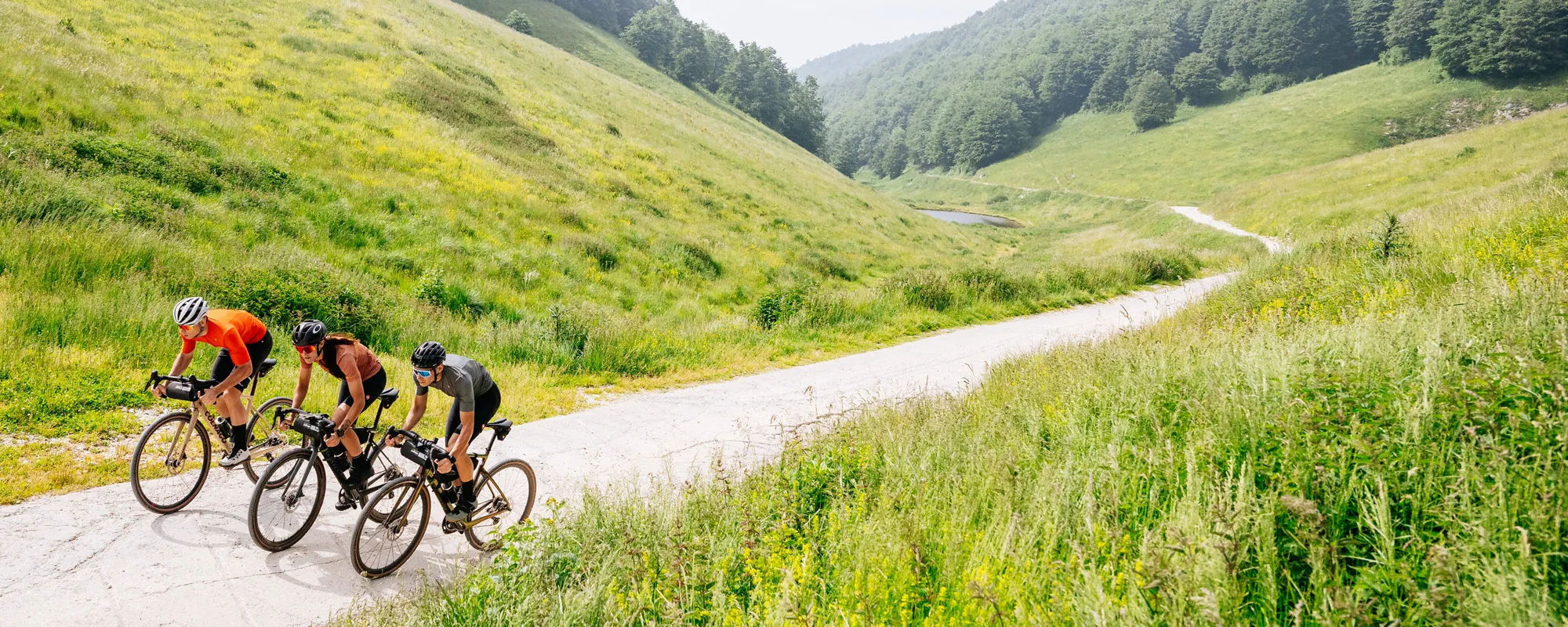 three gravel riders wearing castelli on gravel road