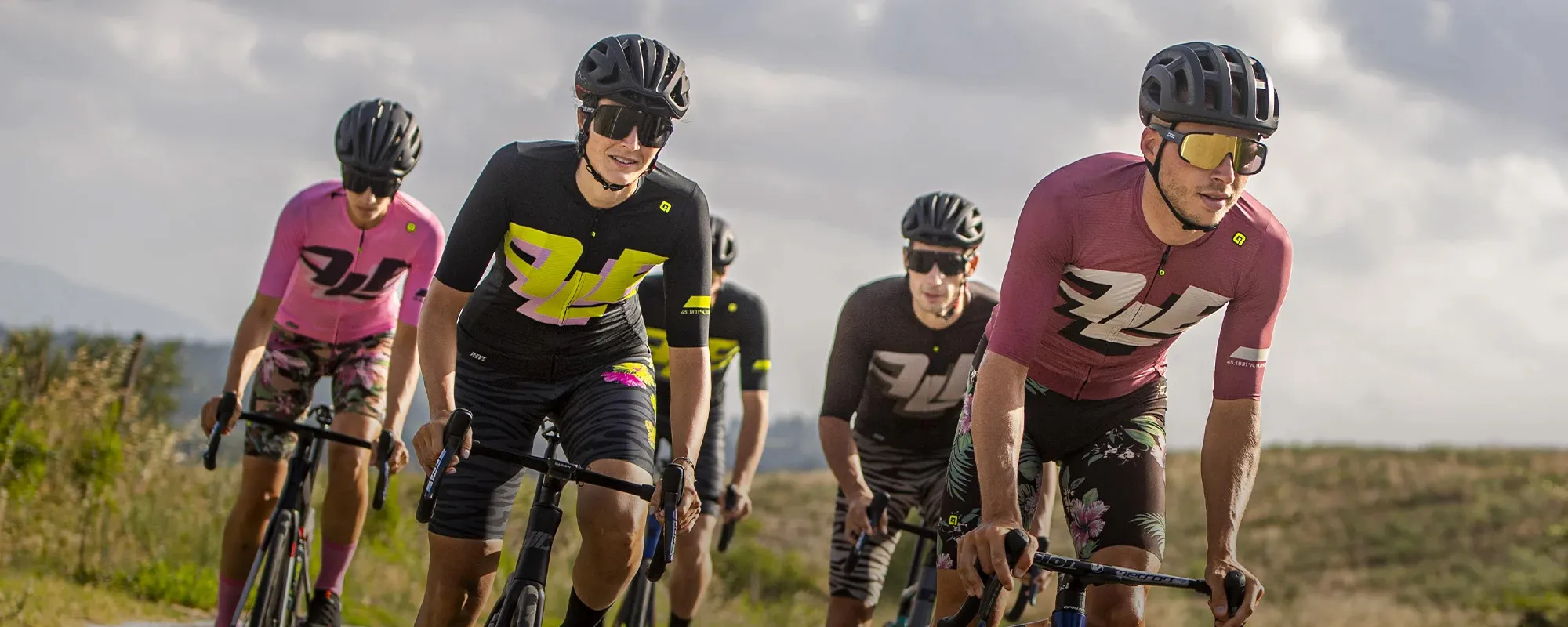 A bunch or road cyclists riding in Ale cycling kit