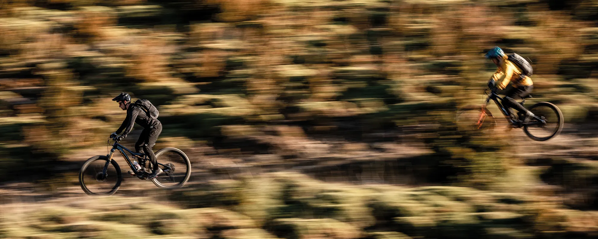 riders on orbea mountain bikes ride downhill