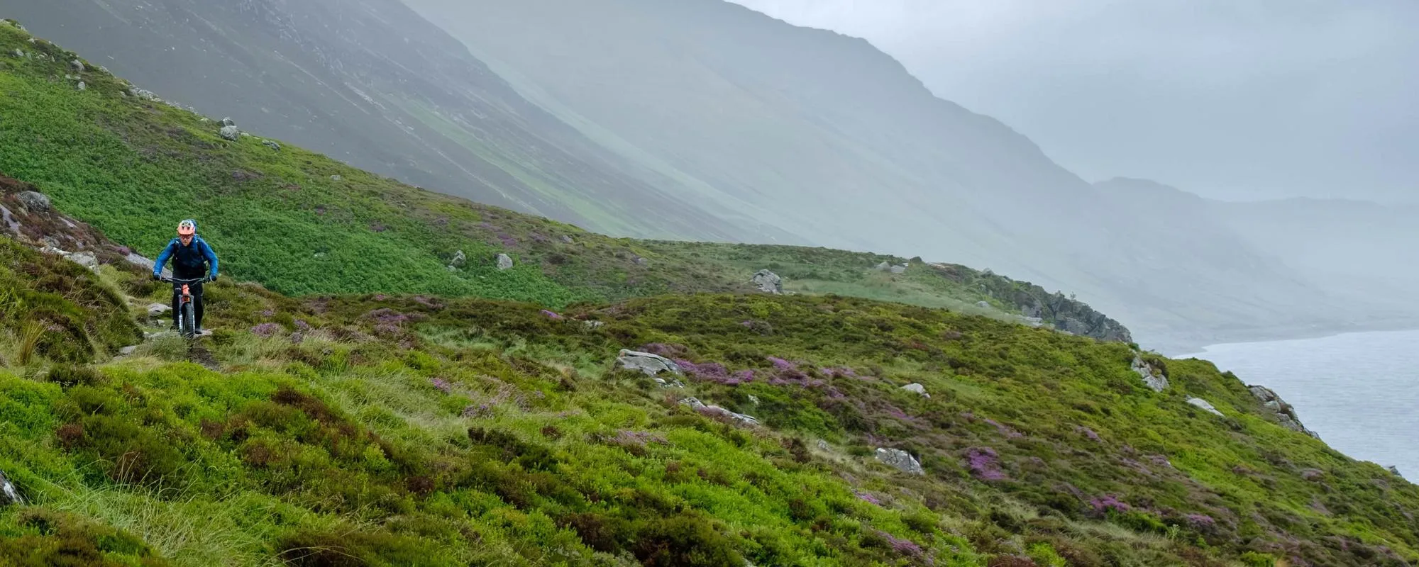 mountain biker on mountain in the rain