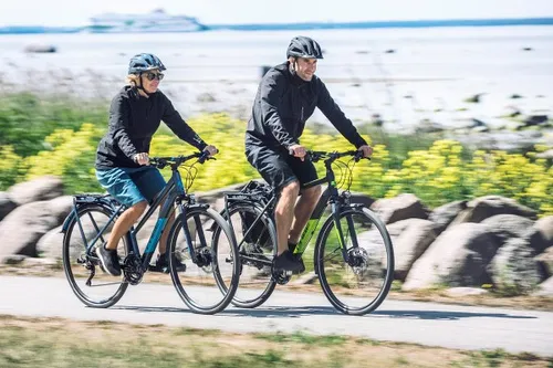 two cyclists riding touring bikes