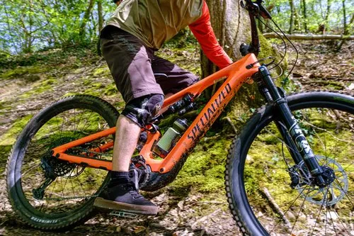 mountain biker riding trails in shorts in the summer