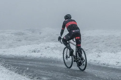 Cyclist riding in cold snowy conditions