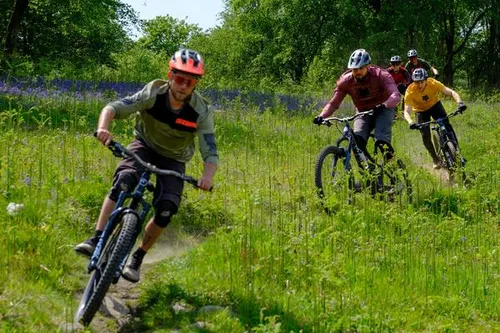 mountain bikers riding in a train on a spring day