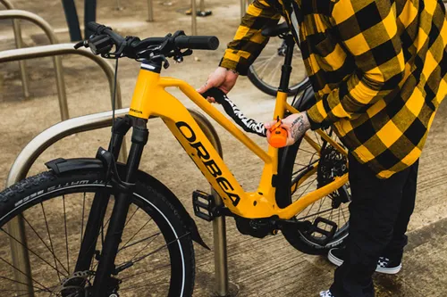 cyclist locking bike with security lock