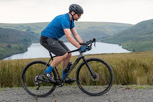 riding a gravel bike past a lake