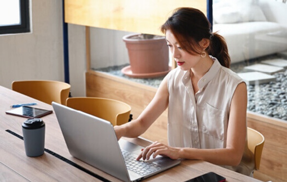 woman using laptop to analyse information