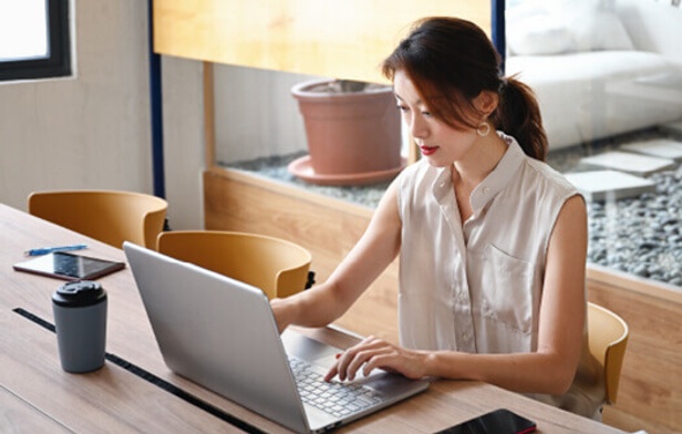 woman using laptop to analyse information