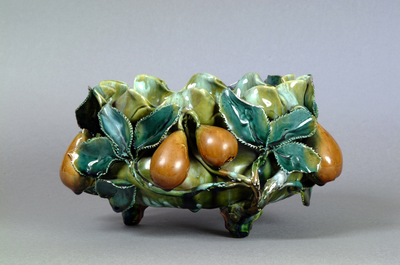 Photograph: Late nineteenth century Benthall Pottery Co. Salopian Decorative Art bowl on three feet. Decorated with Benthall Raised Work in majolica style with applied fruit (pears) and foliage in green and deep yellow glazes. Dated to c.1880-1900.