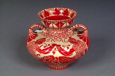 Photograph: Late nineteenth century ruby lustre earthenware Maws and Co. pelike style vase inscribed 'Skoal'. Designed by Walter Crane and produced between 1885-1901.